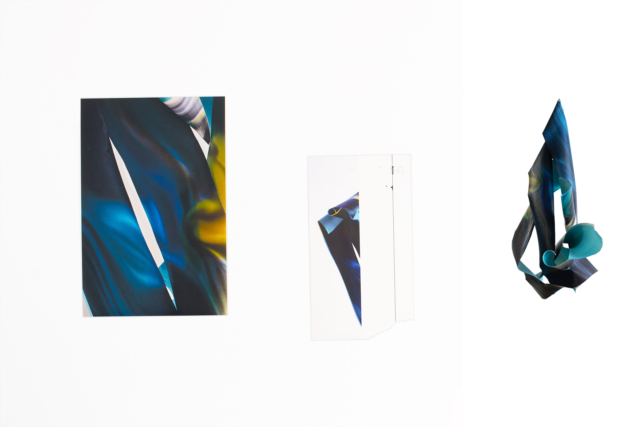 Detail view showing photo paintings and photo sculpture from Fugitive States, deep blues and teals with slashed light forms